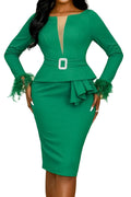 Green dress with ruffled sleeves and a belt on a peach background