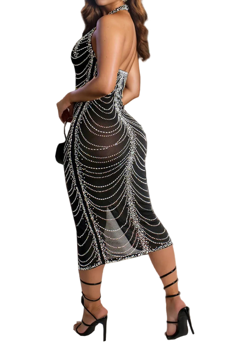 Woman wearing a black and silver beaded dress in an indoor setting