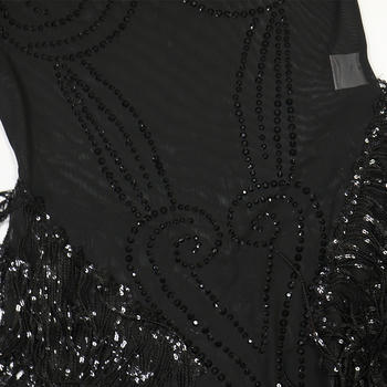 Black dress with sequin and fringe details on a white background