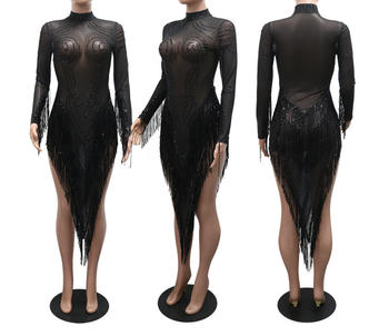 Black sheer dress with long sleeves and a high slit on a mannequin.