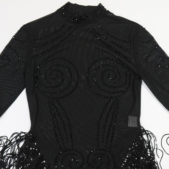 Black beaded dress with intricate patterns on a white background