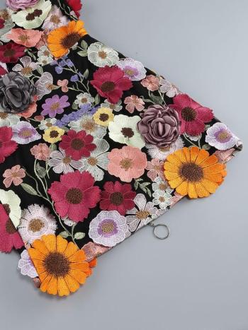 Embroidered fabric with colorful flowers on a gray background