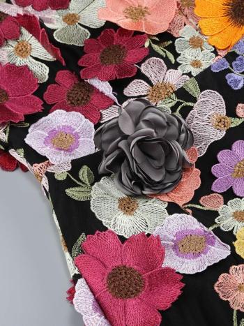 Embroidered fabric with colorful floral patterns on a black background