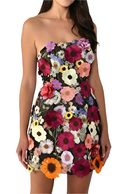 Woman wearing a strapless dress with a colorful floral pattern on a white background
