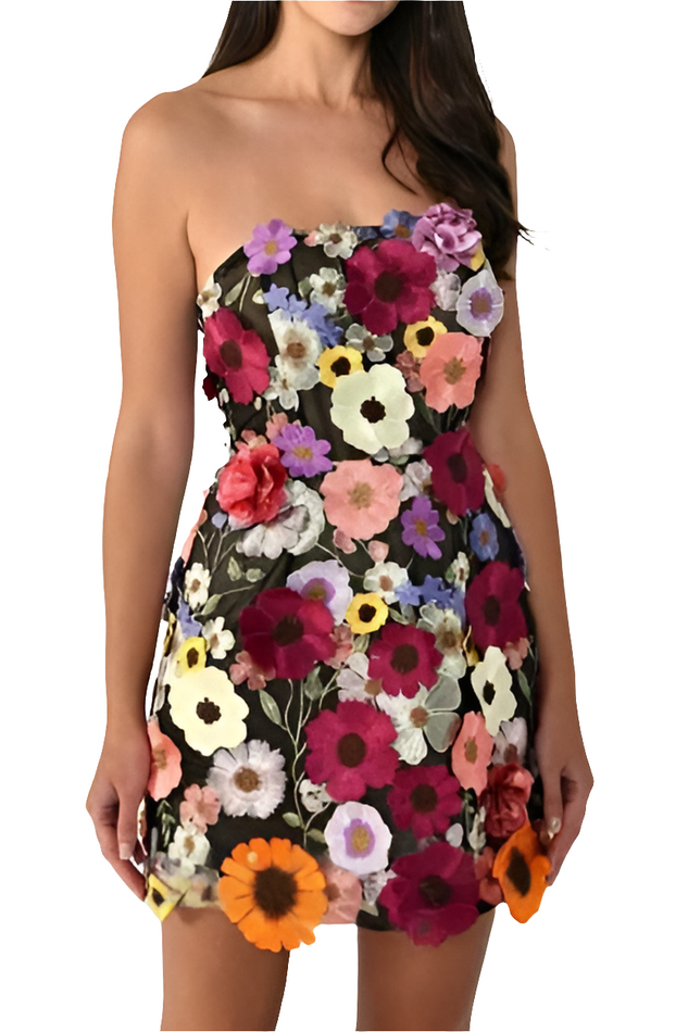 Woman wearing a strapless dress with a colorful floral pattern on a white background