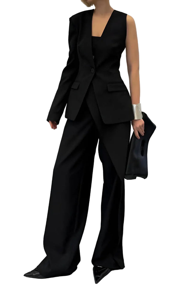 Person wearing a black outfit with wide-leg pants against a gray background