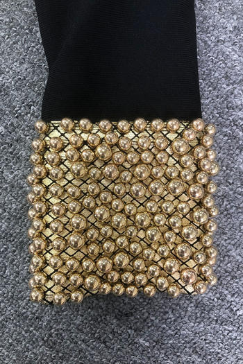 Gold beaded Sleeve on a gray textured background