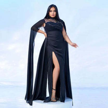 Woman wearing a black evening gown with a cape on a light blue background
