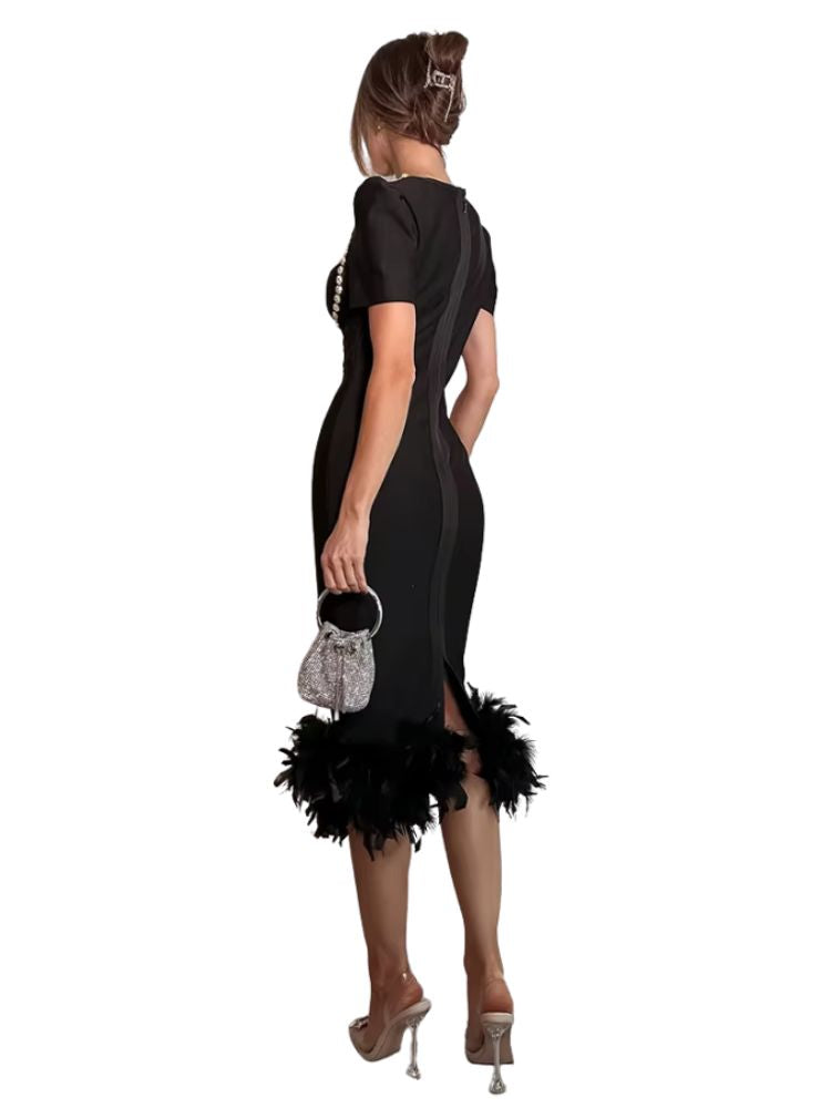 Woman wearing a black dress with feather details on a white background