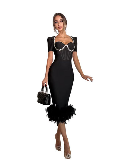 Woman wearing a black dress with feather details on a white background