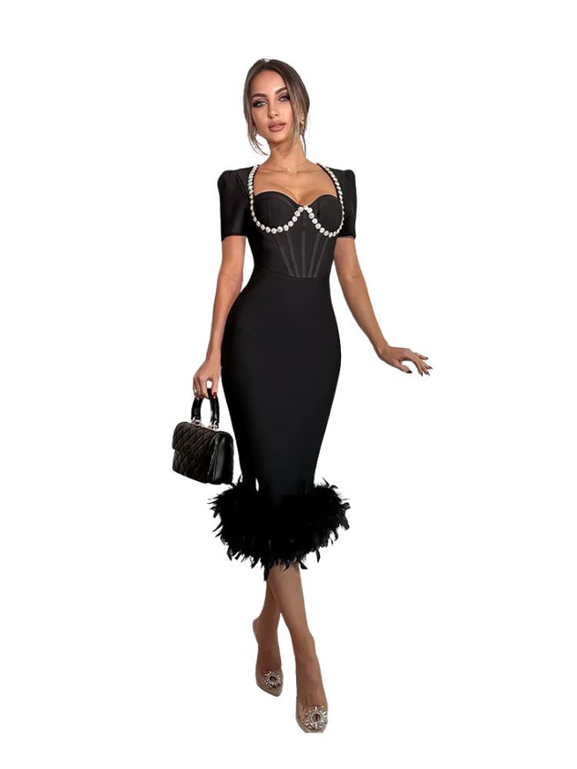 Woman wearing a black dress with feather details on a white background