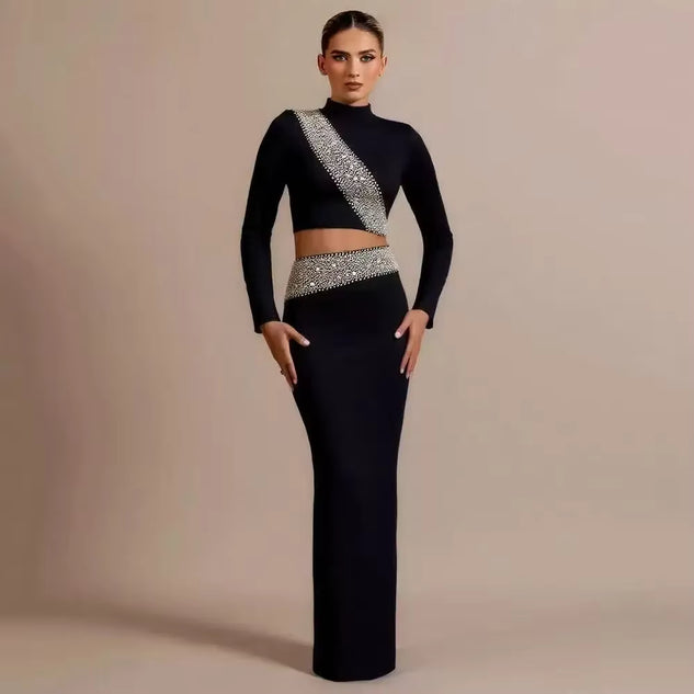 Woman wearing a black outfit with silver embellishments on a beige background