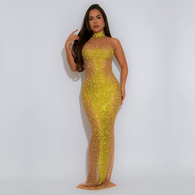Woman wearing a yellow sequin dress against a white background