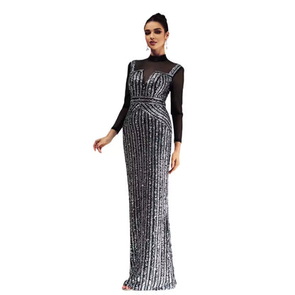Woman wearing a black and silver evening gown on a white background