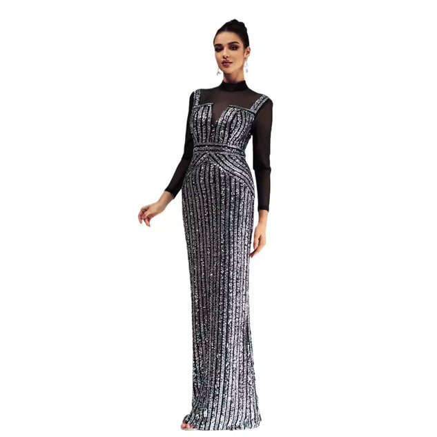 Woman wearing a black and silver evening gown on a white background
