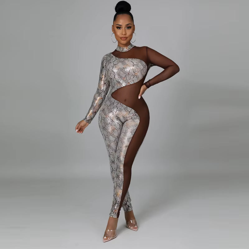 Woman wearing a patterned jumpsuit with cut-out design on a gray background
