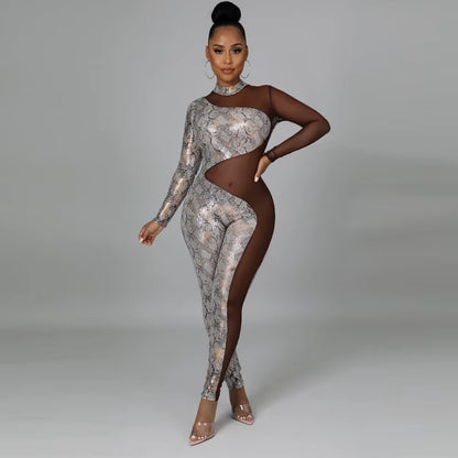 Woman wearing a patterned jumpsuit with cut-out design on a gray background
