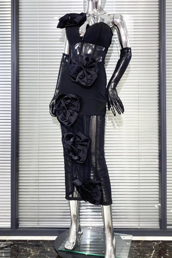 Black dress with floral details on a mannequin against a window blinds background