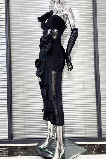 Black dress with floral details on a mannequin against a window blind background
