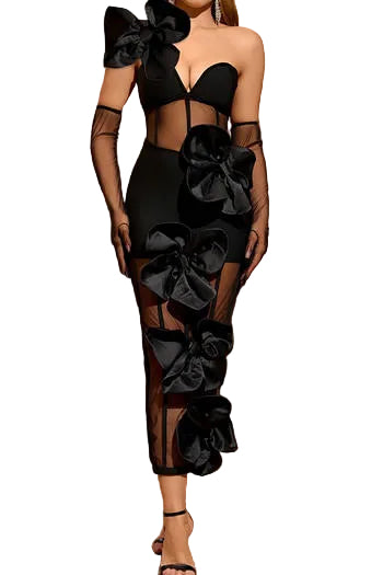Black dress with large bows worn by a model in an elegant interior setting