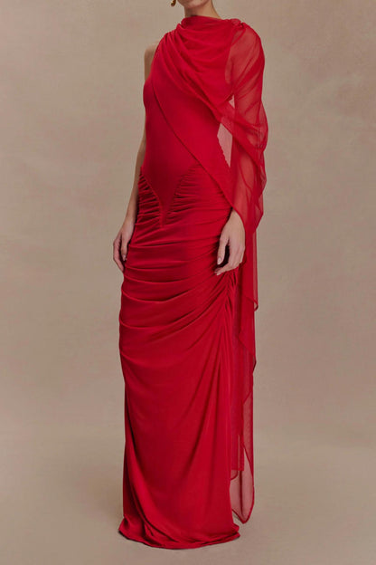 Red evening gown with sheer overlay on a beige background