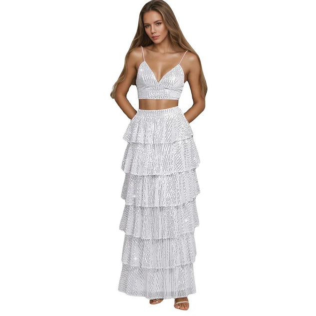 Woman wearing a white tiered dress with thin straps on a white background